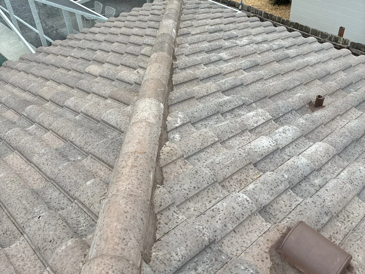 Tile ridge and roof vent detail on a Siesta Key re-roof in Sarasota