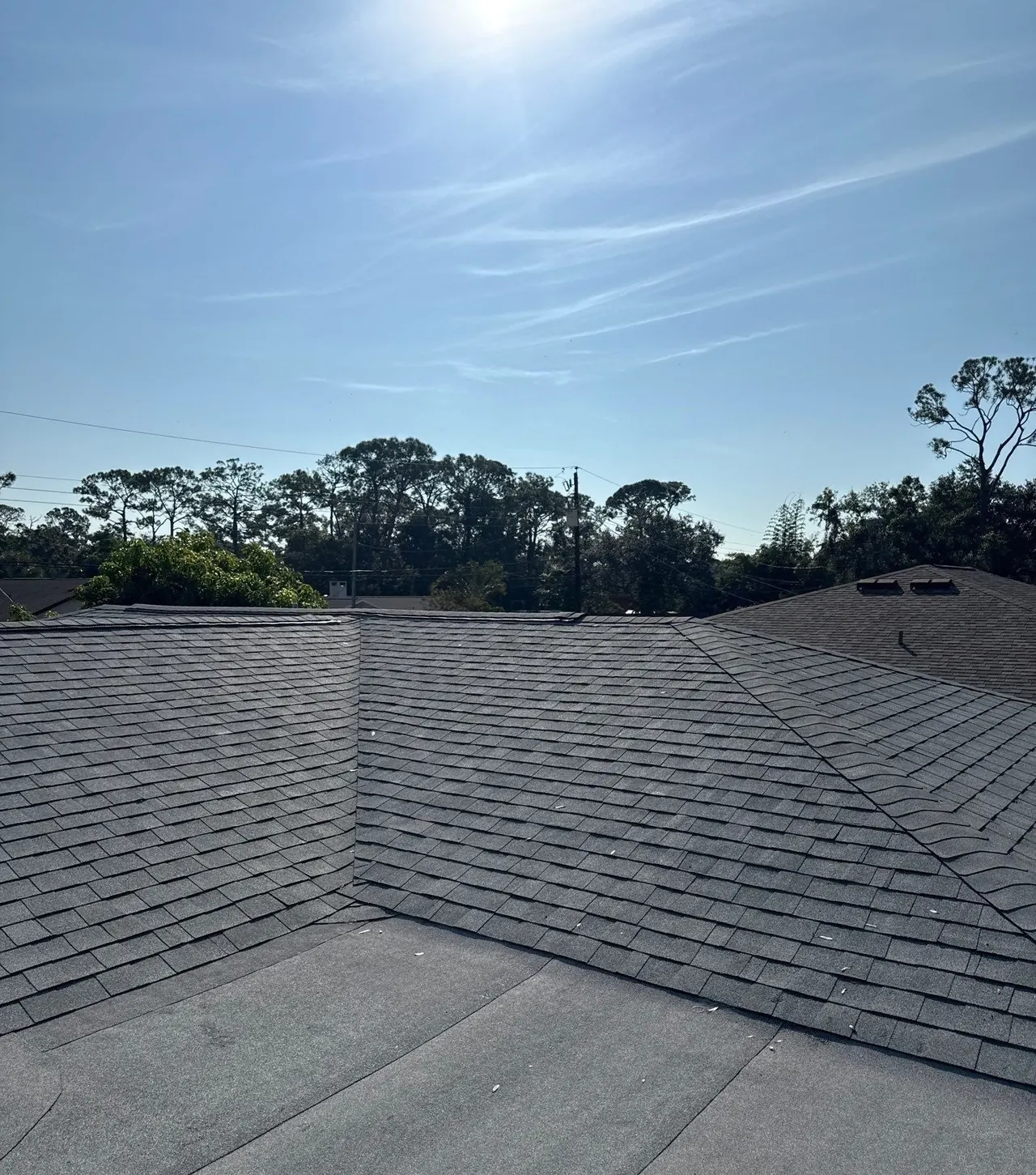 New architectural shingle roof meeting a low-slope section on a Sarasota home
