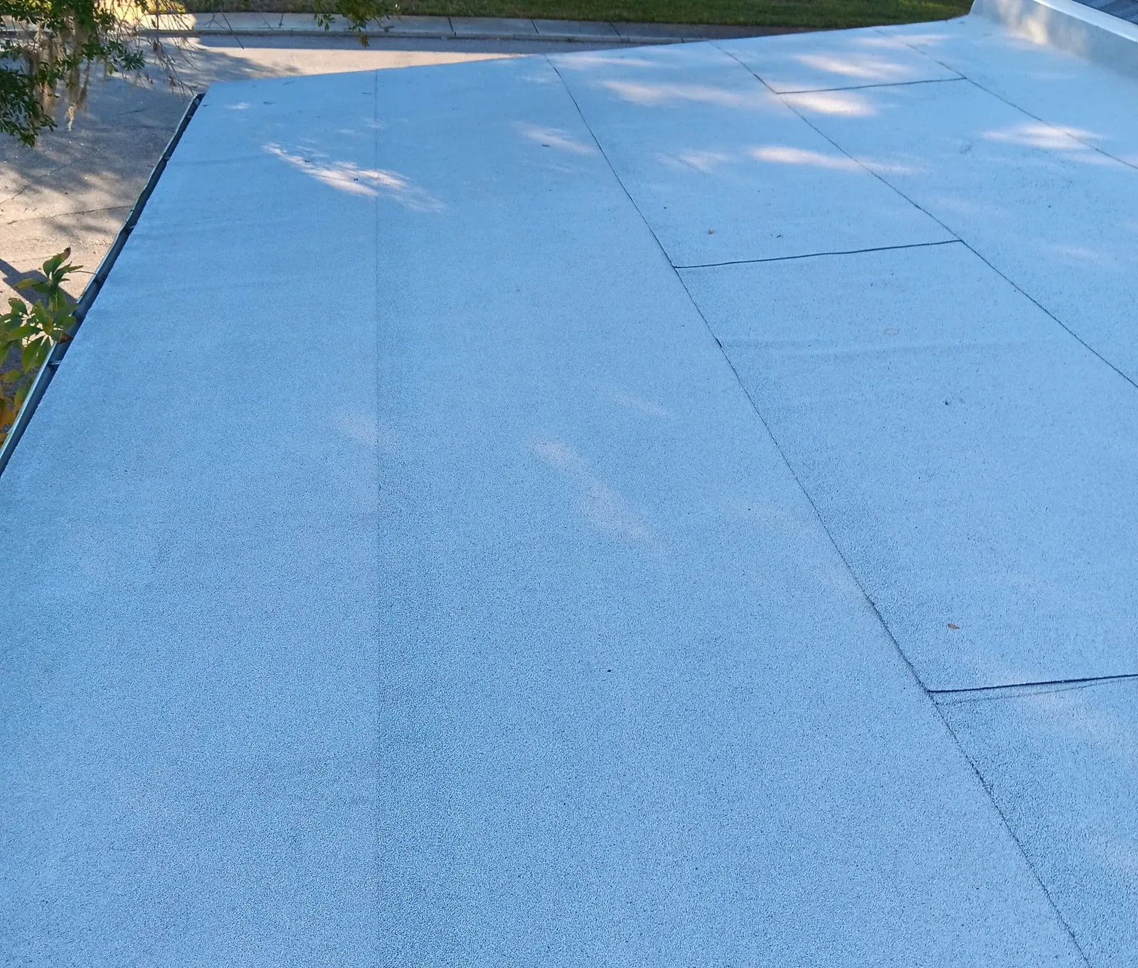 Finished white granulated cap-sheet flat roof with edge metal on a Neal re-roof in Bradenton, near Sarasota